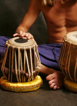 Man playing the nigerian drum in studio