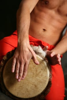 Man playing the nigerian drum in studio