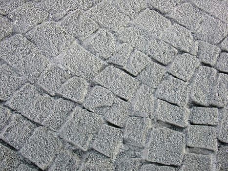 Stone pavement covered with frost