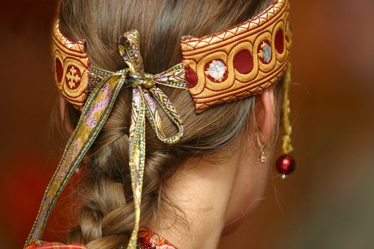 The image of Russian national ornament on a head of the woman