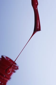 The image of a brush with a red paint