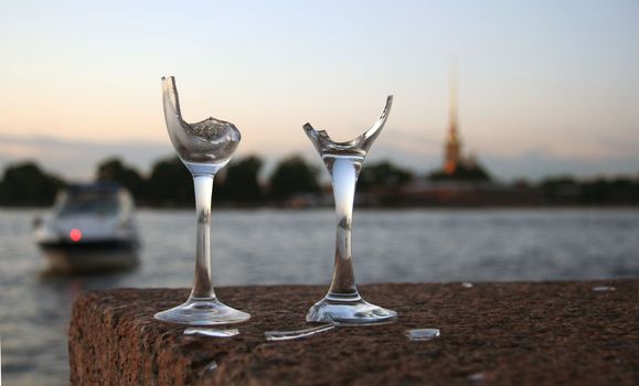 Two wine glasses broken for good luck on the river embankment