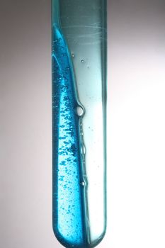 Test tube with a dark blue liquid on a white background