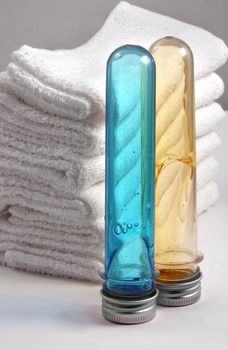 White towels and two bottles with shampoo