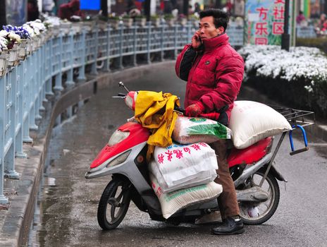 Chinese motorcyclist in shanghai street