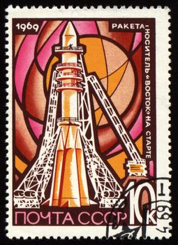 Postage stamp printed in USSR shows space rocket Vostok on launch pad Baikonur, circa 1969