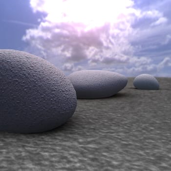Three cobble-stones on a surface in beams of the sun passing through clouds (light abstraction)