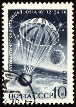 Postage stamp printed in USSR shows landing of soviet automatic station Luna-16, circa 1970