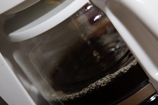 A close-up of coffee brewer, brewing the morning coffee.