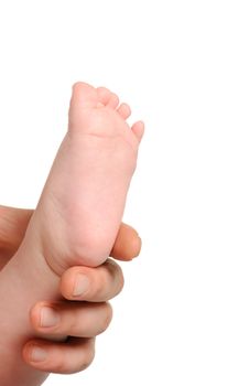 Foot the baby in adult hands. Age of the baby of 8 months.