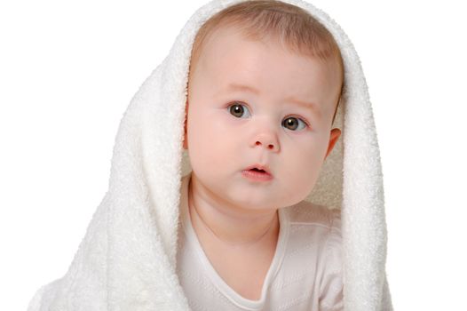 The baby under a towel. Age of 8 months. It is isolated on a white background