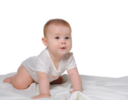 The baby on a bedsheet. Age of 8 months. It is isolated on a white background