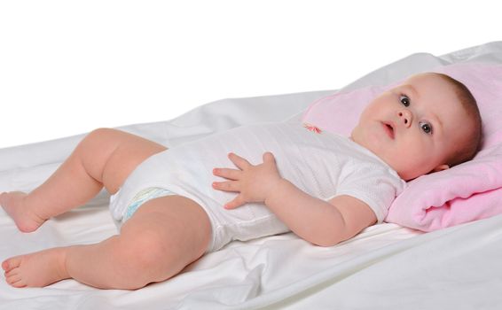 The baby lays. Age of 8 months. It is isolated on a white background