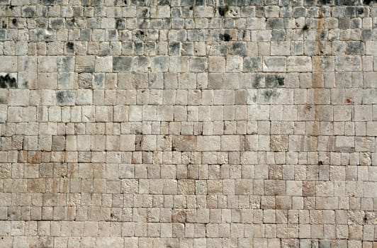 A closeup of a stone wall at Chichen Itza.
