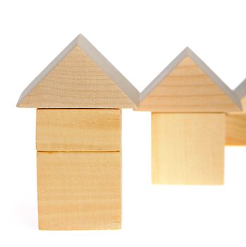 The wooden house. Children's toys - wooden cubes. It is isolated on a white background