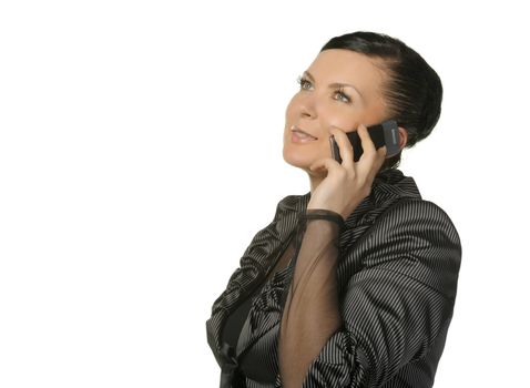 The woman talks by a mobile phone. It is isolated on a white background.