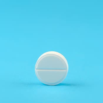 White tablet on a blue background. A photo close up