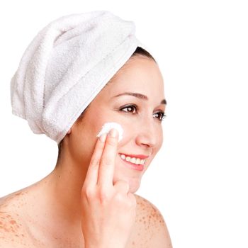 Beautiful happy smiling woman face applying exfoliating cream as anti-aging skincare treatment at spa, isolated.