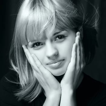 Portrait of the young attractively girl.Blue cold tone. Hair of "wheaten" color. A dark back