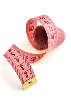 Measuring tape of the tailor red color. It is isolated on a white background