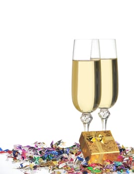Glasses of a champagne. A celebratory tinsel and a box with a gift