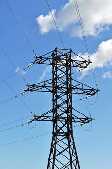 Mast of high voltage electric line on blue sky background