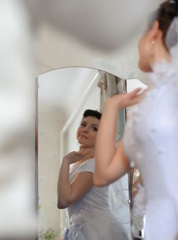 The bride. The young girl in a wedding dress on an abstract background