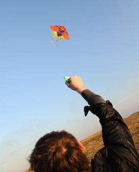 Kite. A colourful kite flying to the dark blue sky