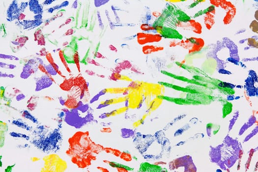 Varicoloured imprint of the hands on white canvas