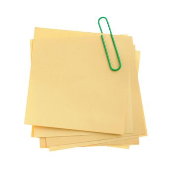 Paper note with green clinch. It is attached red pin on a white background