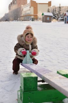 The girl on a swing. Winter, solar frosty weather