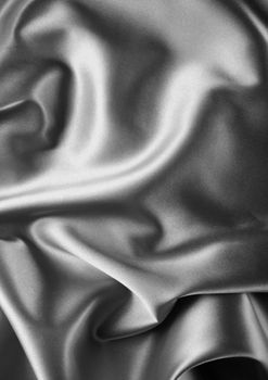 black satin background. A satiny fabric with beautiful light-shadow waves