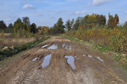 Dirty country road at village outskirts, Russia