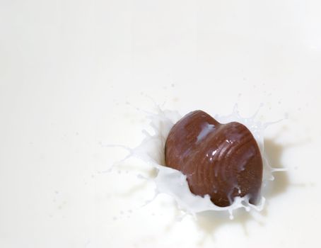 Chocolate heart and milk. Splash in a falling sweet in milk
