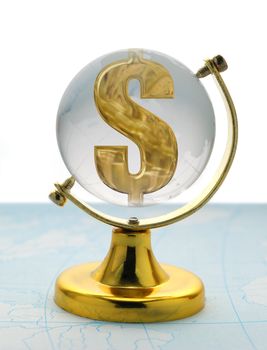 The globe and dollar. The glass globe on a yellow support, with a sign on dollar inside