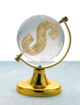 The globe and dollar. The glass globe on a yellow support, with a sign on dollar inside