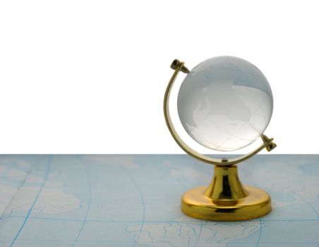 The globe. The glass globe on the yellow support, isolated on a white background