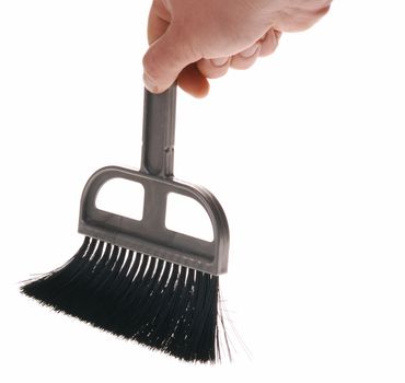 Brush in man hand. The tool for cleaning it is isolated on a white background