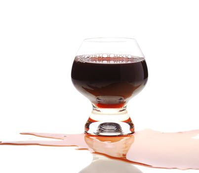 The spilled red wine. Wine poured on a surface, is isolated on a white background