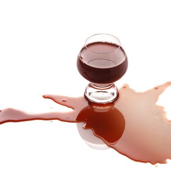 The spilled red wine. Wine poured on a surface, is isolated on a white background