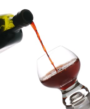 Red wine. Wine poured in a glass, is isolated on a white background