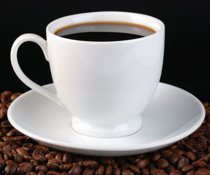 Cup of coffee. A background with coffee grains and a white cup. A photo close up 