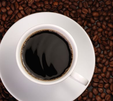 Cup of coffee. A background with coffee grains and a white cup. A photo close up 