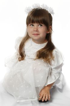 The girl in a white dress. It is isolated on a white background. Age 3 years