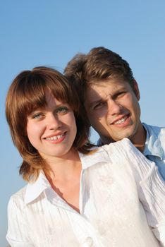 men and women. Happy family on a background of the blue sky