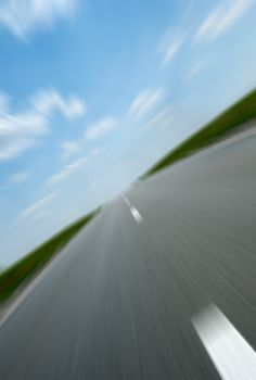 Asphalt road. A transport highway with the blue sky. A transport highway with the blue sky