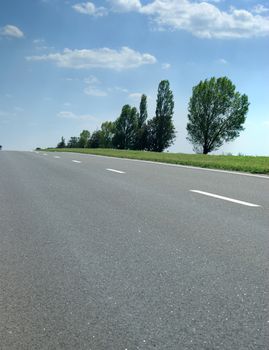 Asphalt road. A transport highway with the blue sky. A transport highway with the blue sky