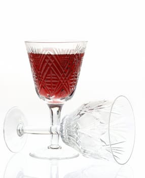 Wine. A glass vessel with wine, a red grape drink