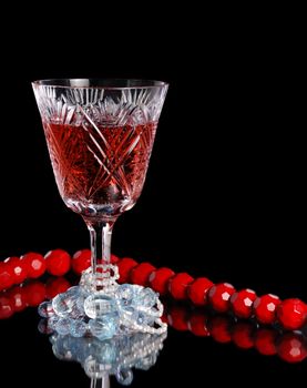 Wine. A glass vessel with wine, a red grape drink