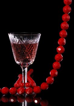 Wine. A glass vessel with wine, a red grape drink